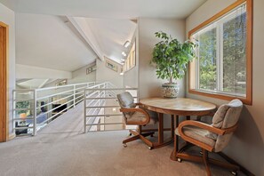 A room with a round table, two chairs, a potted plant, and a window with blinds. - 1 Colonial- Primary Suites, Hot Tub, SHARC, A/C, Steps to Village & SHARC! (Sunriver)