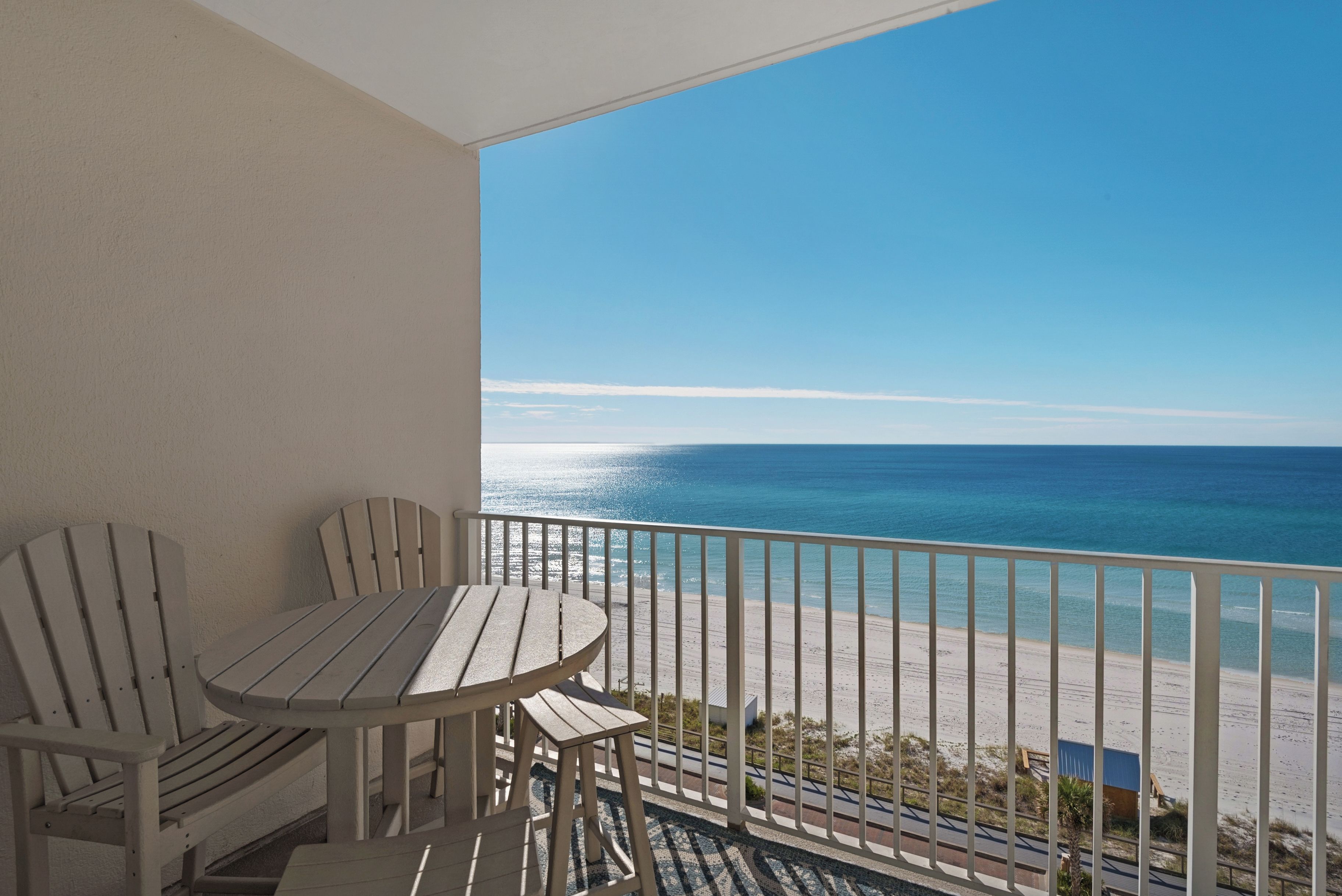A balcony with a view of the beach.