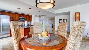 A modern kitchen with wooden cabinets, a stainless steel refrigerator, and a microwave.