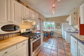 Enjoy cooking in this well-equipped kitchen with modern appliances, stainless steel stove, and microwave.