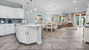 A spacious kitchen with white cabinetry, a central island, and pendant lighting. - Best of Gulf Place at Your Doorstep Heated pools/Walk to Shops/Restaurants (Santa Rosa Beach)