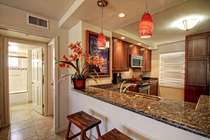 Enjoy cooking in this well-equipped kitchen with an island, microwave, and coffee maker.