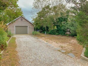 A gravel driveway leading to a wooden garage with a covered entrance. - 221 Stites Avenue Unit #5(3BR/2BA)Beach Block (Cape May Point)