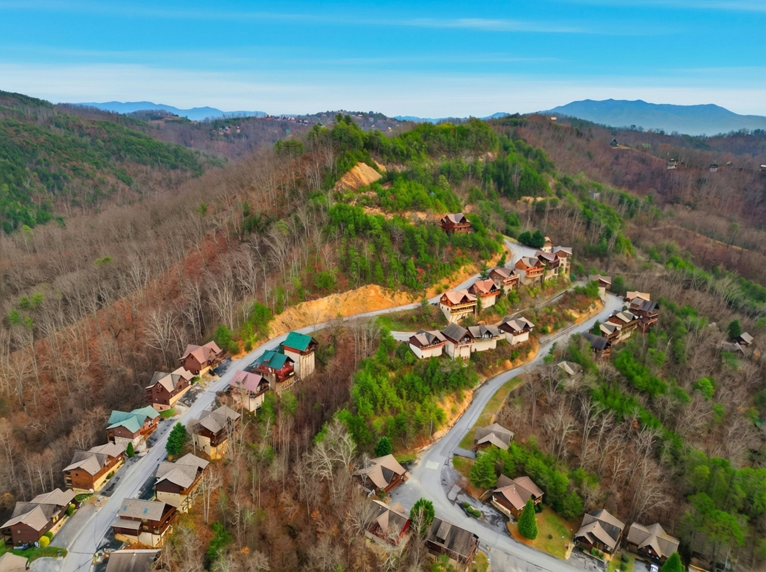 An aerial view of a residential area with houses arranged along winding roads, surrounded by hills and sparse vegetation.