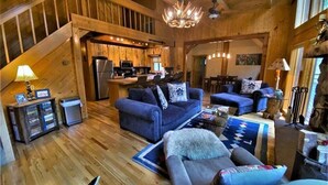 A spacious wooden interior with a living area, kitchen, and dining space. - Stunning Riverside Cabin, Private Hot Tub, Spacious Yard, Grill (Durango)