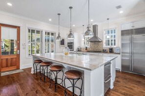 Enjoy cooking in this well-lit kitchen with a large island and stainless steel appliances.