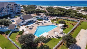 A resort with a swimming pool, lounge chairs, and a view of the ocean. - Great for Large Groups. 1 Minute to Beach. Private Heated Pool. Carriage House (Watersound)