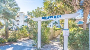 Ingresso privato recintato verso un'area spiaggia chiamata Gulfplace, con un cartello che indica l'accesso riservato alla spiaggia.