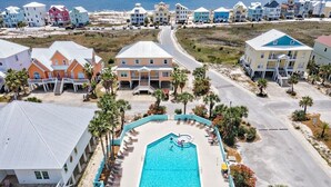 A resort with a central swimming pool, multiple buildings, and a beach view. - ShellChase | 5BR/3.5BA Martinique Home | Sleeps 12 | Gulf Views + Pool (GULF SHORES)