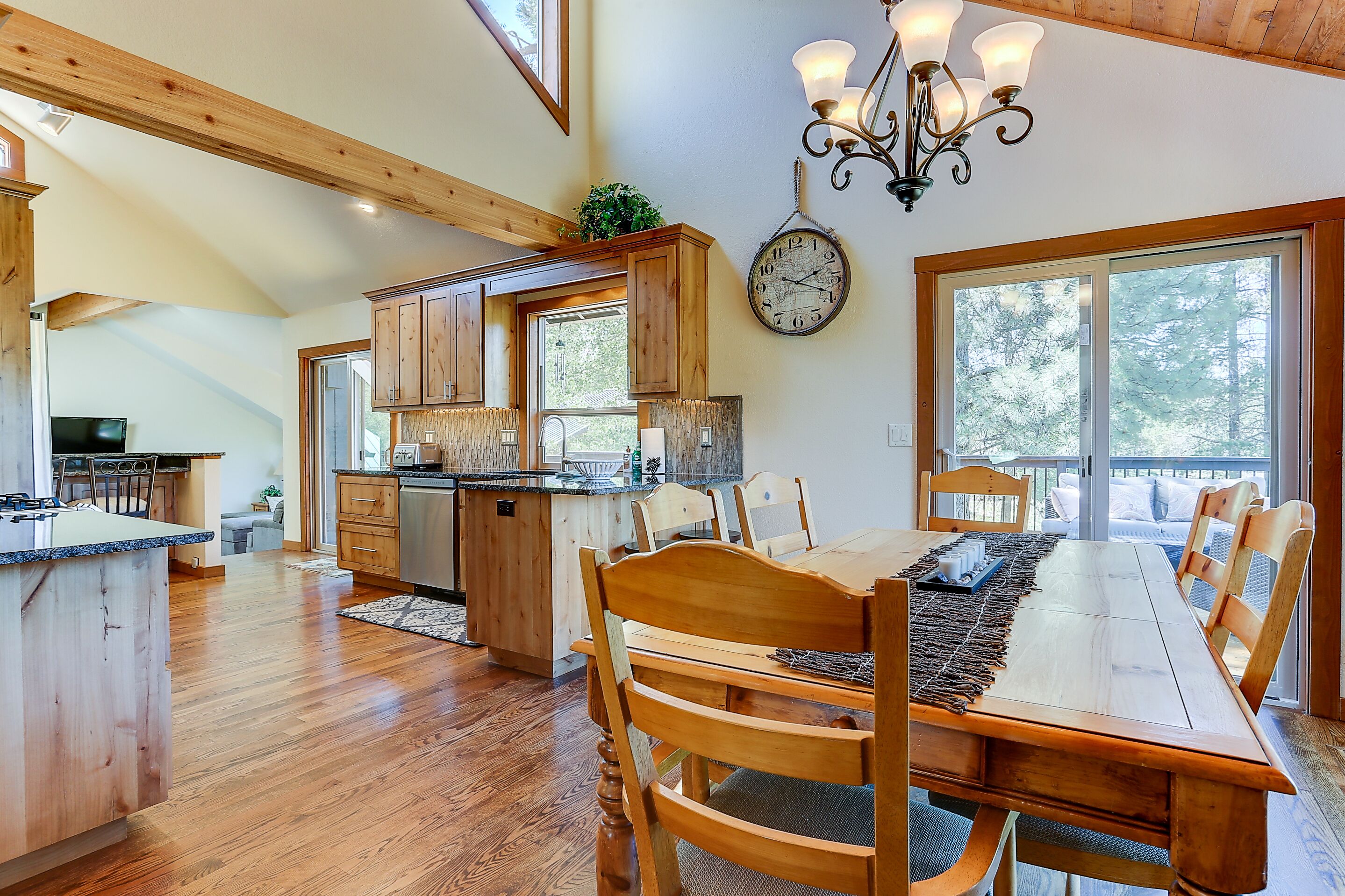 A spacious kitchen with wooden cabinets, a large island, and a dining area with a long table and chairs.