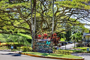 Stroll through the serene garden of Kapalum Golf Villas, surrounded by lush greenery and vibrant flowers.