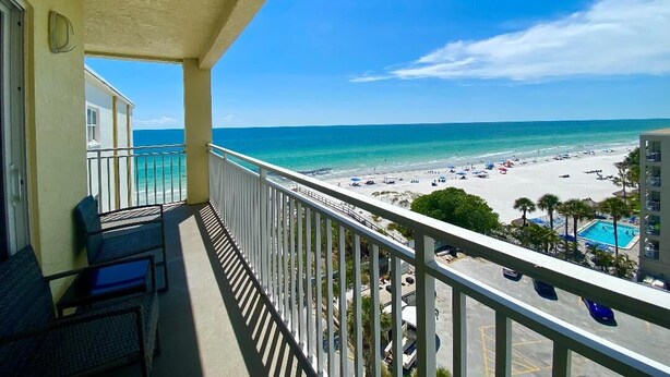 A balcony with a view of a beach and a pool. - Beachside & Amazing Views! 3BR/3BA, Heated Pool/Spa  606 (Redington Shores)
