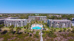 A resort with multiple buildings, a central swimming pool, and surrounding greenery. - 238 Shorewood- 2nd Floor Landscape View steps to the beach. (Hilton Head Island)