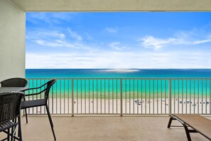 A balcony with a view of a beach and ocean. - BEACH FRONT RESORT!! SLEEPS UP TO 9! BEACH SERVICE WITH 2 CHAIRS AND UMBRELLA INCLUDED! (Panama City Beach)