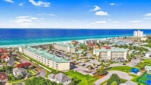 A coastal resort with multiple hotel buildings, a beachfront, and a tennis court. - Gulf View View,Beach Service, Maravilla 2303! (Miramar Beach)