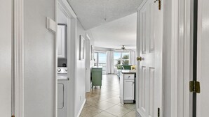 A hallway leading to a kitchen with a view of the outdoors. - Gulf View View,Beach Service, Maravilla 2303! (Miramar Beach)