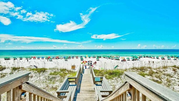 A beach with a wooden boardwalk leading to the water, sandy beach, and umbrellas. - Gulf View View,Beach Service, Maravilla 2303! (Miramar Beach)