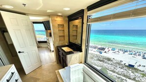 A bathroom with a large window overlooking a beach. - Large corner unit with spacious balconies! 4106 BS1 (Miramar Beach)