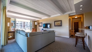 Relax in a spacious living area with a comfortable sofa, flat-screen TV, and seating area.
