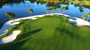 A golf course with sand bunkers, water hazards, and palm trees. - *FREE GOLF-2Golf Carts! Screened Porch~Free Activities! Pet Friendly, BUNGALO (Miramar Beach)