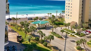 A high-rise building with a view of the beach and ocean.