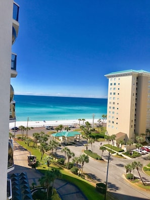 A high-rise building with a view of the beach and ocean.