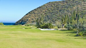 A golf course with a clear view of the ocean and a hilly backdrop. - Oceanfront Villa w/ Hot Tub, Sports Courts, Cook & Steps to Swimmable Beach (La Paz)