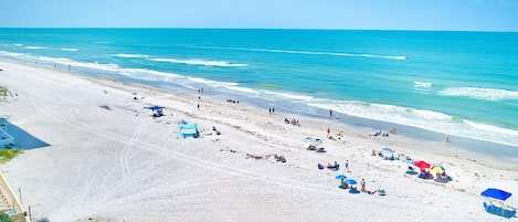 Relax on the beach with comfortable sun loungers and umbrellas.