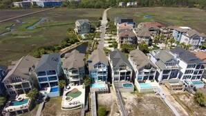 A residential area with multiple two-story houses, a central road, and a small body of water. - 2 Collier, Oceanfront, Dogs OK, Pool, Free Golf, Elevator (Hilton Head)