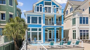 A multi-story house with a pool area, including lounge chairs and a barbecue grill. - 2 Collier, Oceanfront, Dogs OK, Pool, Free Golf, Elevator (Hilton Head)