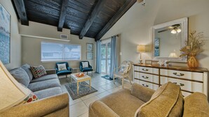 A spacious living room with a high ceiling, a sofa set, a coffee table, and a dining area. - Beach Getaway! Pet-friendly! Chateau La Mer 15E! (Destin)