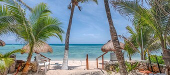 Spacious and serene, beachfront condo with AC, WiFi, onsite restaurant, pool!