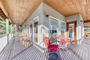 Relax in a serene outdoor space with a table and chairs, and a comfortable chair by the glass wall.