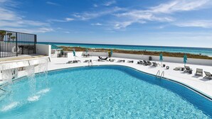 A swimming pool with a view of the beach and ocean.