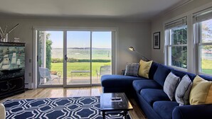 A living room with a blue sofa, a coffee table, and a fish tank.