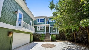 A two-story house with a garage, a front porch, and a driveway leading to the entrance. - 18 Sand Dollar, Oceanfront, Pool, Free Golf, Elevator, Great Views (Hilton Head Island)