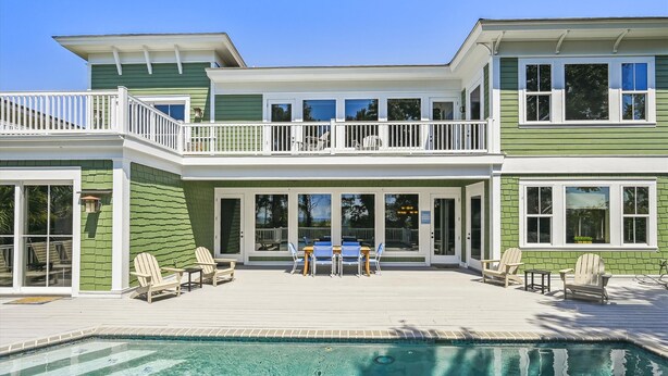A two-story house with a pool, outdoor seating, and a covered patio. - 18 Sand Dollar, Oceanfront, Pool, Free Golf, Elevator, Great Views (Hilton Head Island)