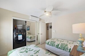 A room with two beds, a washing machine, a ceiling fan, and a lamp. - Oceanfront Oasis at Royal Mauian 518: Sapphire Views & Prime Location Await! (Kihei)