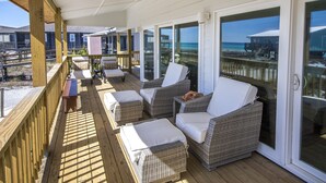 A covered outdoor deck with wicker furniture and a view of the beach and ocean. - One Lot From Beach, Gulf View, Private Beach Boardwalk, Dune Allen Beach (Santa Rosa Beach)