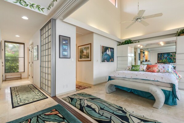 A bedroom with a bed, a ceiling fan, and artwork on the walls. - Aloha Condos, Keauhou Kona Surf and Racquet Club, Condo 1-306, Oceanfront (Kailua Kona)