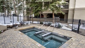 A rectangular pool with steps, surrounded by a brick patio and a metal fence. - Ski-In and Out in Beaver Creek Village Condo w/ Balcony, Hot Tub, Free Shuttle  (Beaver Creek)