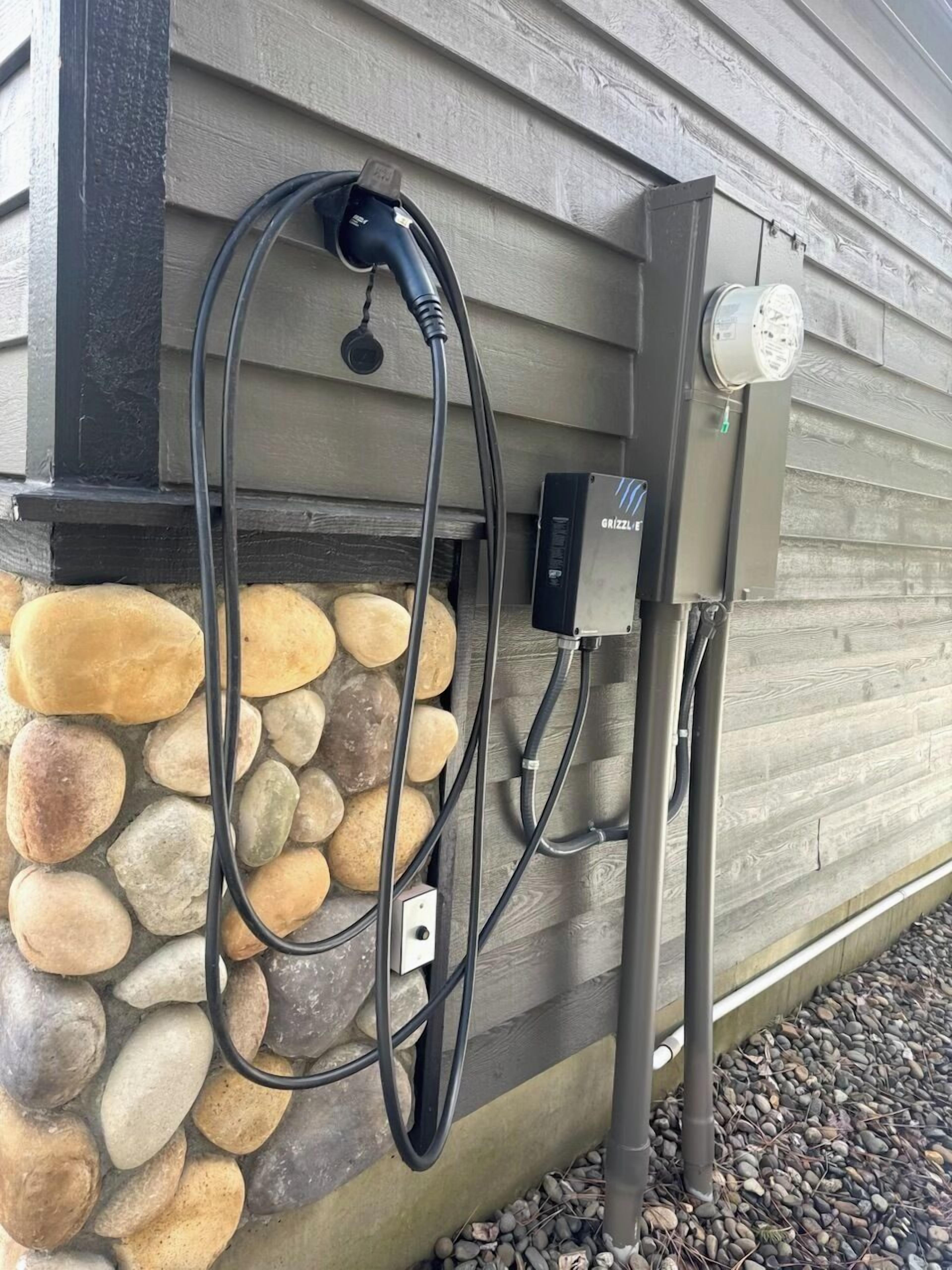 A stone wall with a power outlet and a charging station.