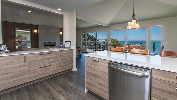 A modern kitchen with a large island, built-in appliances, and a view of the ocean. - Treasure Cove-Hot Tub, Ocean Views & Near Beach (Trinidad)