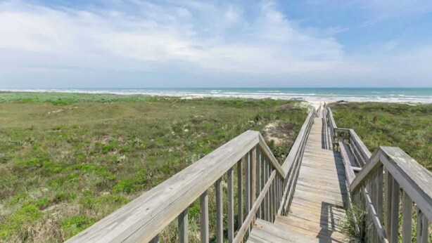 A wooden boardwalk leading to a beach with a clear sky. - Island Breeze Home, Dual Pools & Private Decks (Port Aransas)