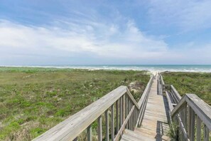 A wooden boardwalk leading to a beach with a clear sky. - Island Breeze Home, Dual Pools & Private Decks (Port Aransas)