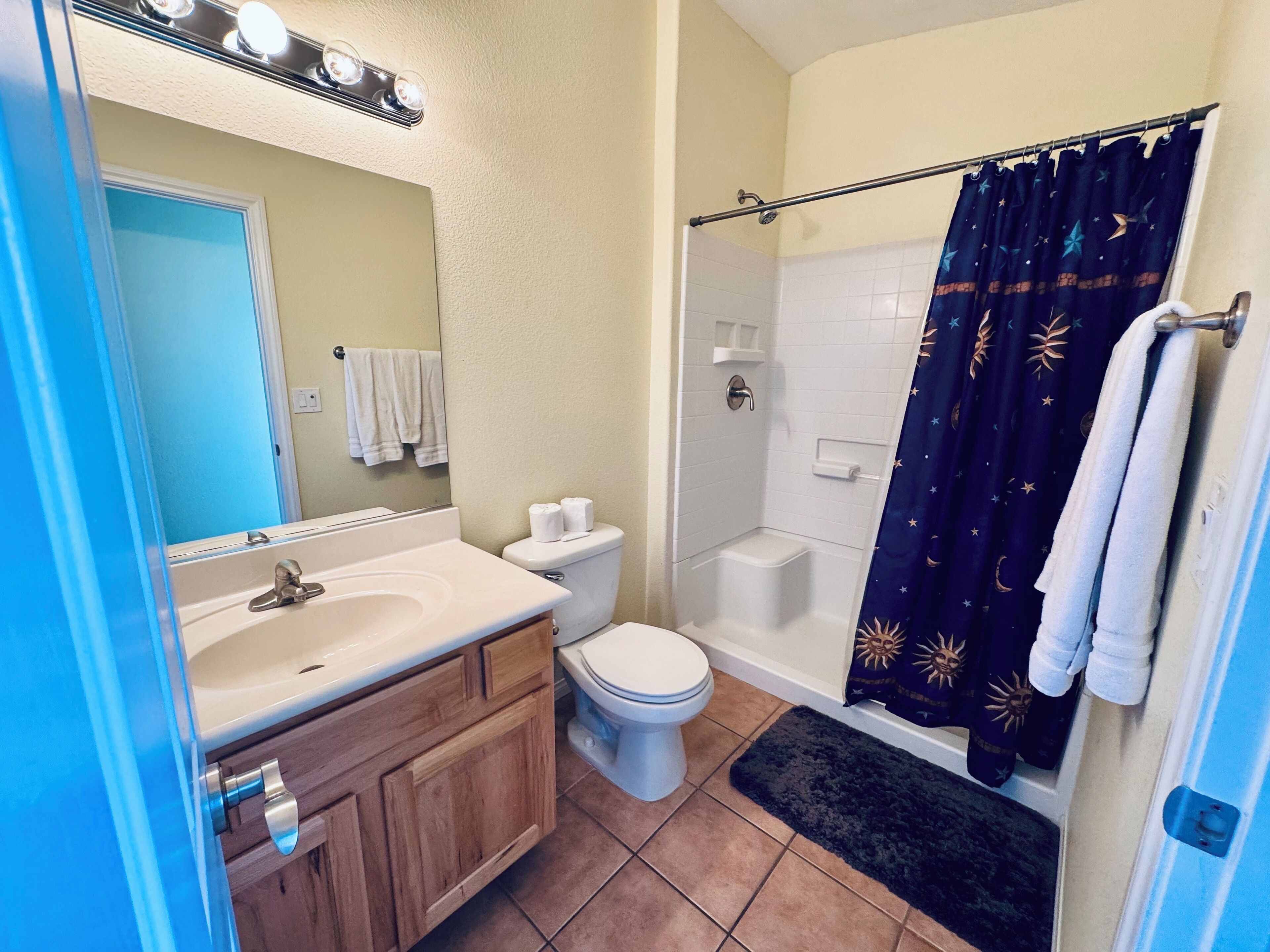 A bathroom with a sink, toilet, and shower.