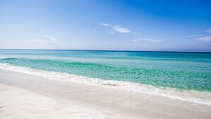 A beach with clear turquoise water and a sandy shore. - Gulf Front, Gorgeous Panoramic Gulf Views, Large Deck, Dune Allen Beach (Santa Rosa Beach)