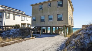 A two-story building with a balcony, located on a sandy beach with a clear view of the ocean. - Gulf Front, Gorgeous Panoramic Gulf Views, Large Deck, Dune Allen Beach (Santa Rosa Beach)