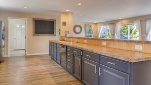 A modern kitchen with a large island, dark cabinets, and a wooden countertop. - Seneca Shores: Attention Wine Trail and Lakefront Enthusiasts! (Himrod)