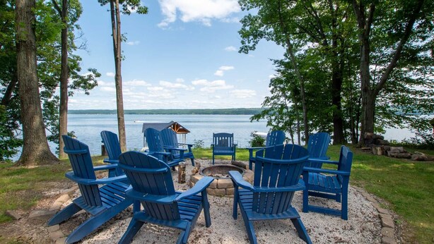 A lakeside seating area with Adirondack chairs, a fire pit, and a small shelter. - Seneca Shores: Attention Wine Trail and Lakefront Enthusiasts! (Himrod)